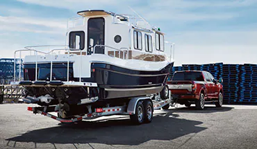 2022 Nissan TITAN Truck towing boat | Passport Nissan in Marlow Heights MD