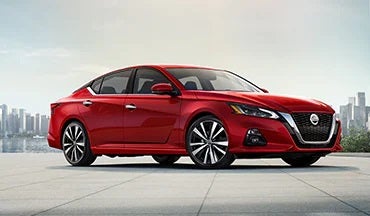 2023 Nissan Altima in red with city in background illustrating last year's 2022 model in Passport Nissan in Marlow Heights MD