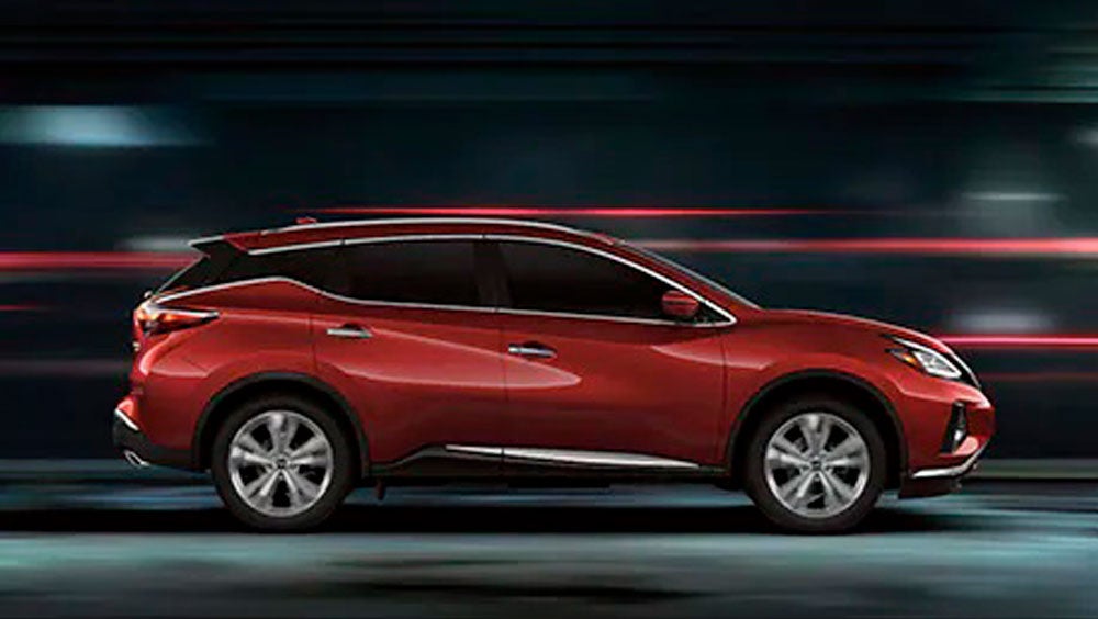2023 Nissan Murano shown in profile driving down a street at night illustrating performance. | Passport Nissan in Marlow Heights MD